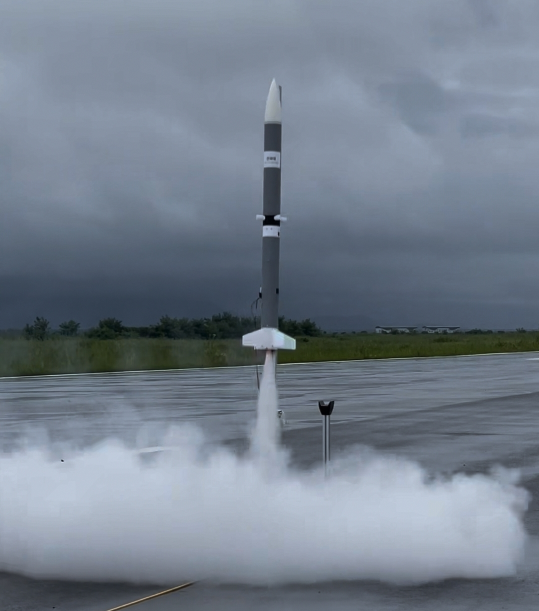 Full rocket and exhaust plume during liftoff from a wet launch pad